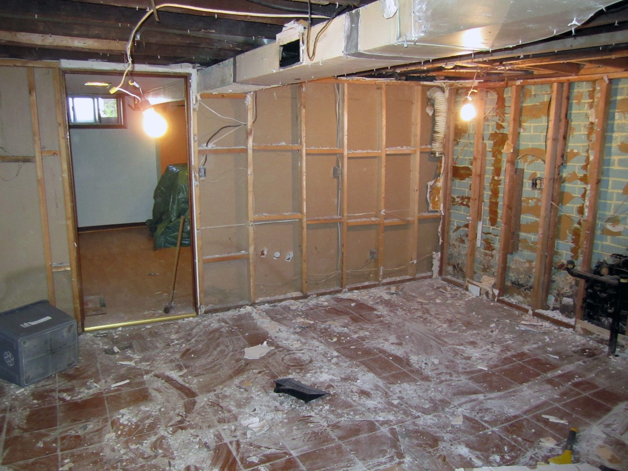demolition during basement remodel. Exposed ventilation systems, studs, plumbing, and electrical.