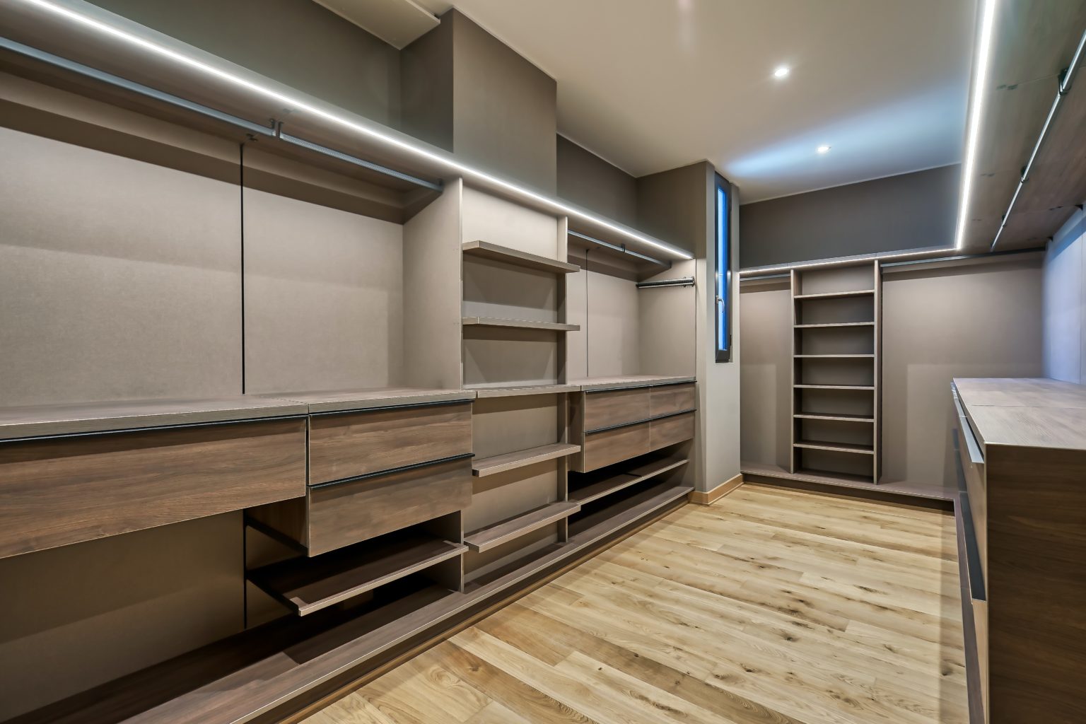 Custom closet made from wood and other materials. Space designed for him and her with places for many different personal items.